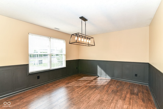6479 Enclave Blvd, Greenwood, IN 46143 - empty room with a wainscoted wall and dark wood-type flooring