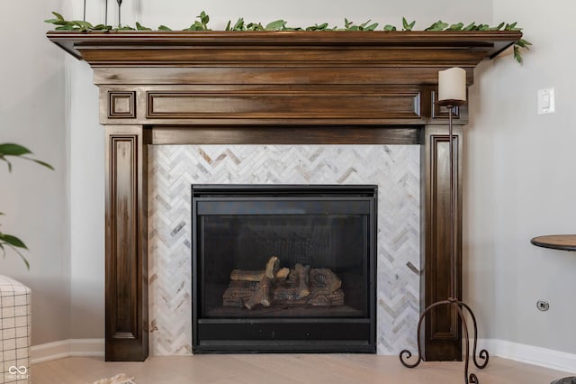 interior details featuring baseboards and a fireplace
