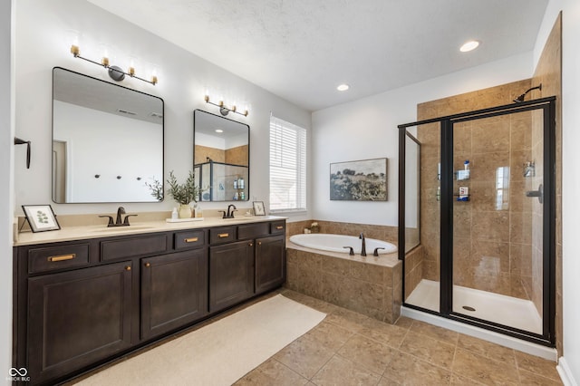 full bath featuring double vanity, a sink, a bath, and a shower stall