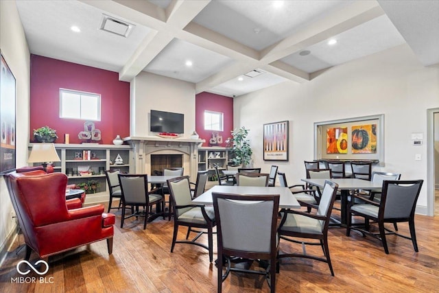 1614 Waterleaf Dr, Westfield, IN 46074 - dining space with coffered ceiling, hardwood / wood-style floors, beamed ceiling, a fireplace, and recessed lighting
