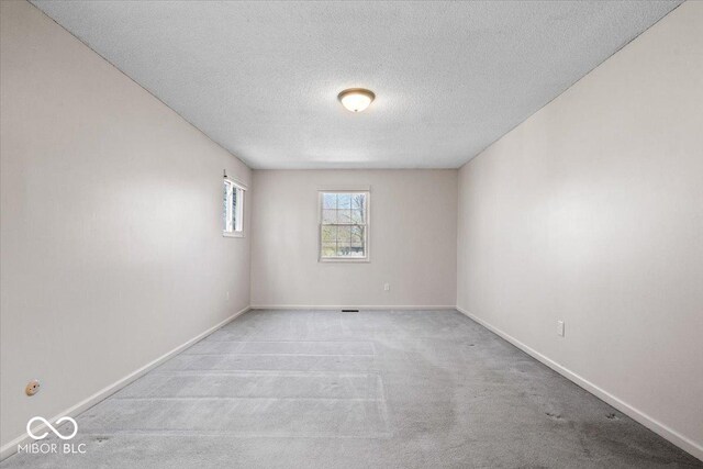 315 Heritage Ct, Fishers, IN 46038 - unfurnished room with carpet floors, a textured ceiling, and baseboards