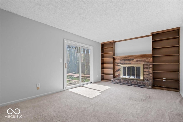 315 Heritage Ct, Fishers, IN 46038 - unfurnished living room featuring baseboards, carpet flooring, a textured ceiling, and a brick fireplace