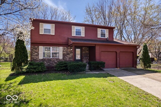 315 Heritage Ct, Fishers, IN 46038 - view of front facade with concrete driveway, fence, brick siding, a garage, and a front yard