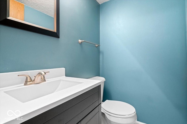 315 Heritage Ct, Fishers, IN 46038 - half bathroom featuring vanity, a textured ceiling, and toilet