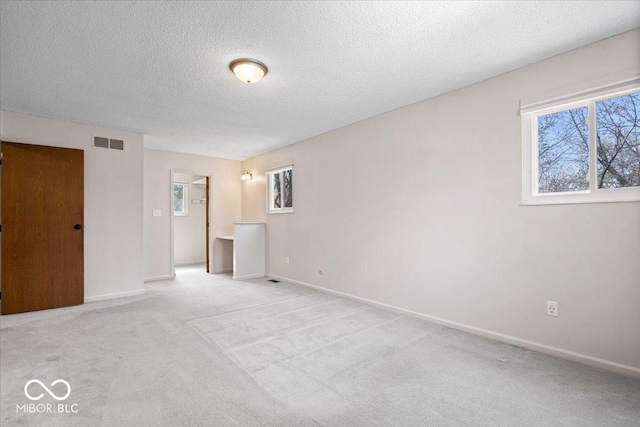 315 Heritage Ct, Fishers, IN 46038 - unfurnished room featuring light carpet, a textured ceiling, visible vents, and baseboards