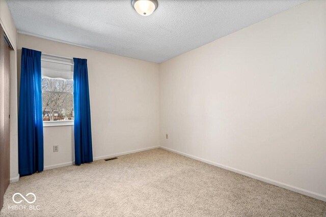 315 Heritage Ct, Fishers, IN 46038 - unfurnished room featuring carpet floors, a textured ceiling, visible vents, and baseboards