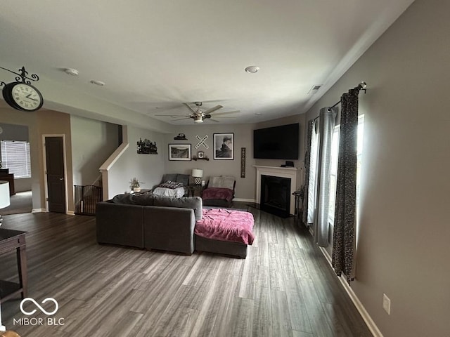 1573 Vera Blvd, Danville, IN 46122 - living area featuring a fireplace, baseboards, a ceiling fan, and wood finished floors