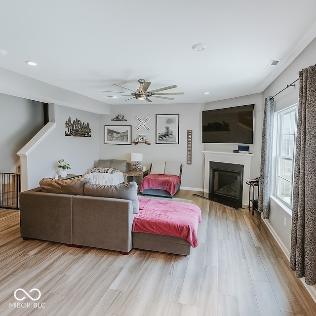 1573 Vera Blvd, Danville, IN 46122 - living room with wood finished floors, ceiling fan, a glass covered fireplace, and recessed lighting