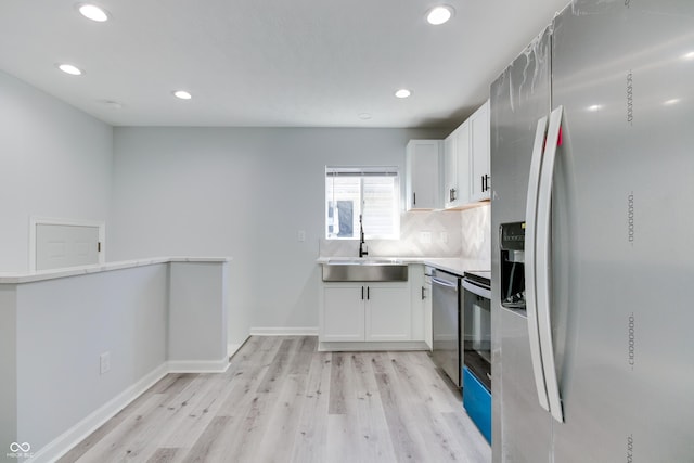 1125 N Colorado Ave, Indianapolis, IN 46201 - kitchen featuring recessed lighting, a sink, light wood-style floors, and appliances with stainless steel finishes