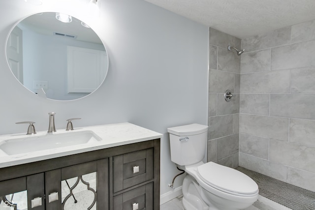 1125 N Colorado Ave, Indianapolis, IN 46201 - full bathroom featuring toilet, vanity, visible vents, and tiled shower