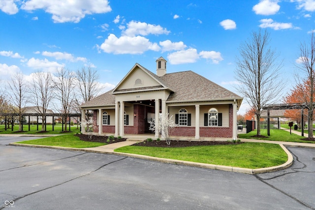 16758 Bingham Dr, Westfield, IN 46074 - view of front facade featuring brick siding, roof with shingles, a front lawn, and covered porch