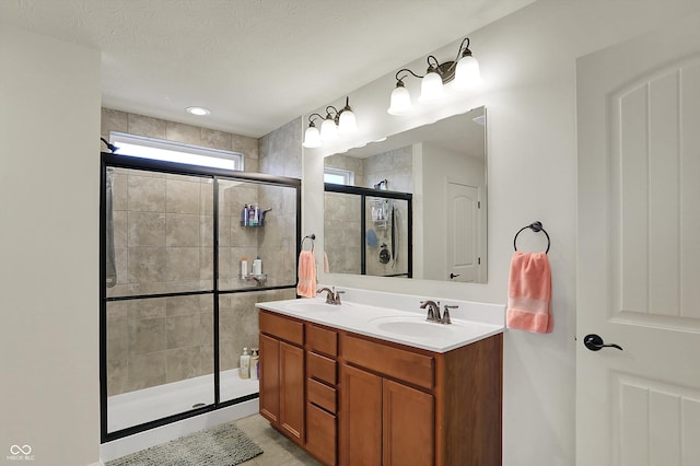 16758 Bingham Dr, Westfield, IN 46074 - full bathroom featuring a stall shower, double vanity, a sink, and tile patterned flooring