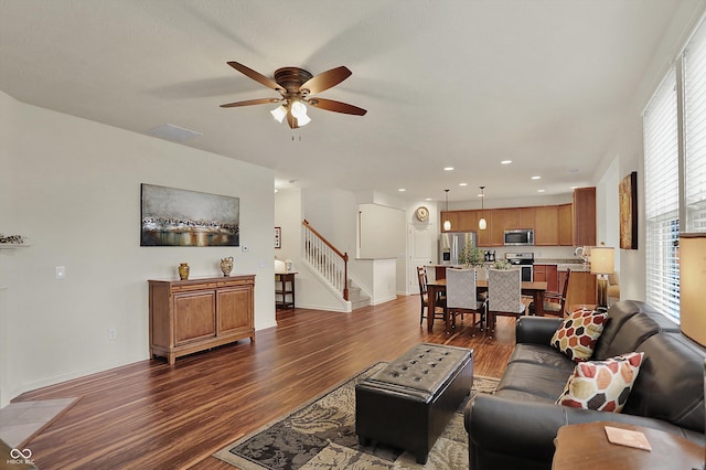 16758 Bingham Dr, Westfield, IN 46074 - living room with a wealth of natural light, stairs, dark wood-type flooring, and ceiling fan