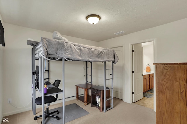16758 Bingham Dr, Westfield, IN 46074 - bedroom featuring a textured ceiling, light colored carpet, visible vents, and connected bathroom