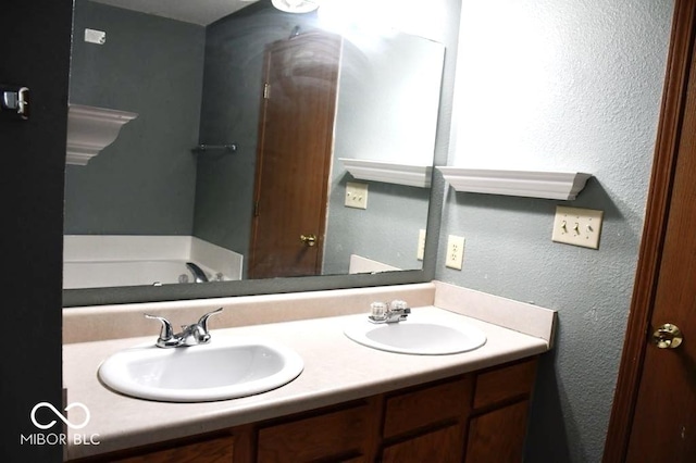 607 Deer Trail Dr, Indianapolis, IN 46217 - full bath with a sink, a tub to relax in, double vanity, and a textured wall