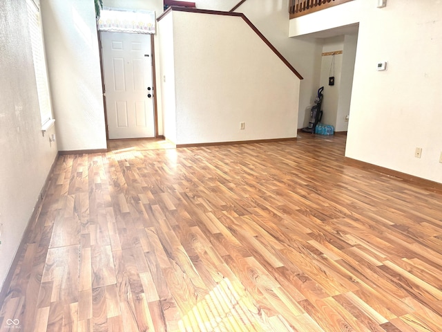607 Deer Trail Dr, Indianapolis, IN 46217 - unfurnished living room featuring baseboards and wood finished floors