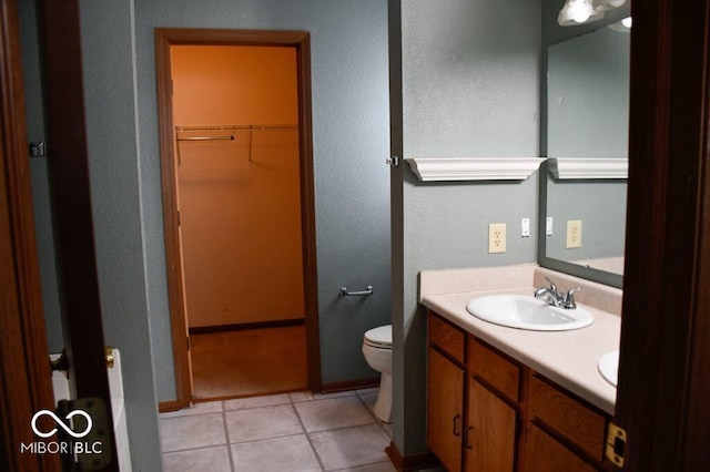 607 Deer Trail Dr, Indianapolis, IN 46217 - bathroom with double vanity, tile patterned floors, toilet, a walk in closet, and a sink