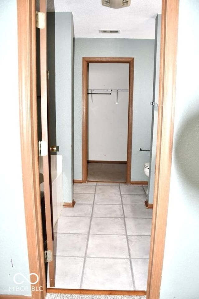 607 Deer Trail Dr, Indianapolis, IN 46217 - corridor featuring light tile patterned flooring and baseboards