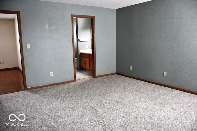 607 Deer Trail Dr, Indianapolis, IN 46217 - spare room with baseboards and carpet floors