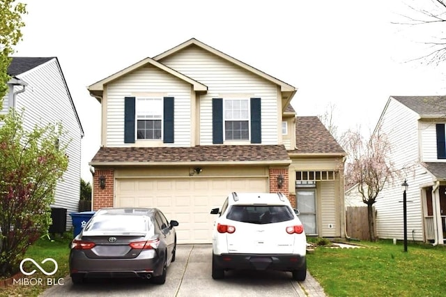 607 Deer Trail Dr, Indianapolis, IN 46217 - view of front of house with a shingled roof, concrete driveway, a garage, and brick siding