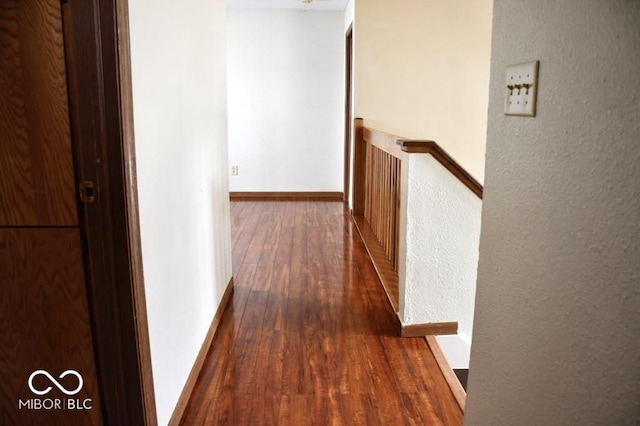 607 Deer Trail Dr, Indianapolis, IN 46217 - hallway with a textured wall, dark wood-type flooring, an upstairs landing, and baseboards