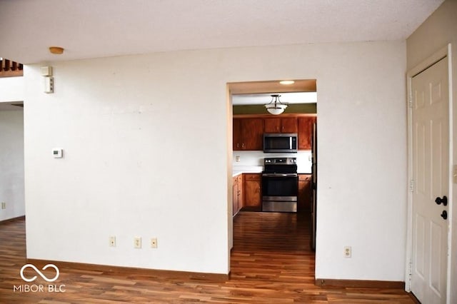 607 Deer Trail Dr, Indianapolis, IN 46217 - kitchen featuring brown cabinetry, wood finished floors, and appliances with stainless steel finishes