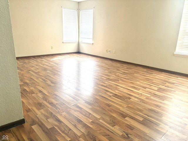 607 Deer Trail Dr, Indianapolis, IN 46217 - unfurnished room featuring a wealth of natural light, hardwood / wood-style flooring, and baseboards