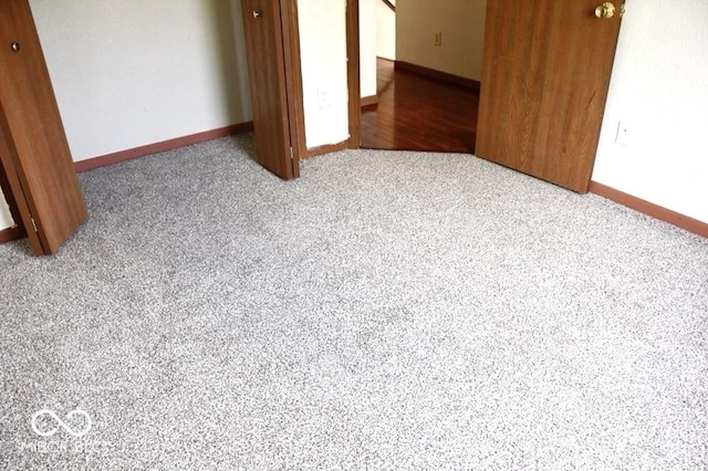 607 Deer Trail Dr, Indianapolis, IN 46217 - unfurnished bedroom featuring a closet, baseboards, and carpet