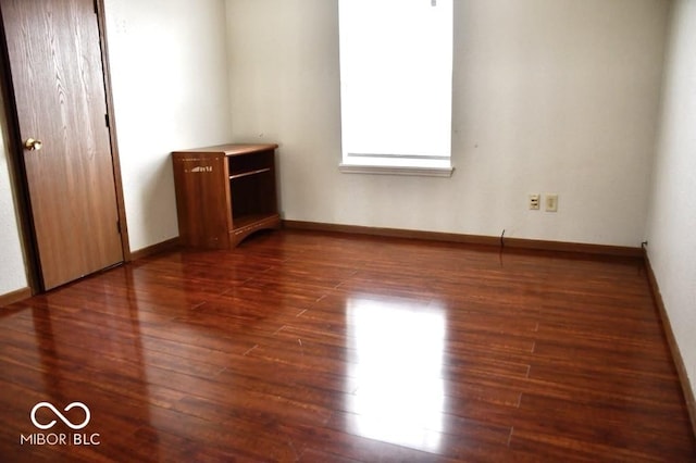607 Deer Trail Dr, Indianapolis, IN 46217 - unfurnished bedroom with dark wood-type flooring and baseboards