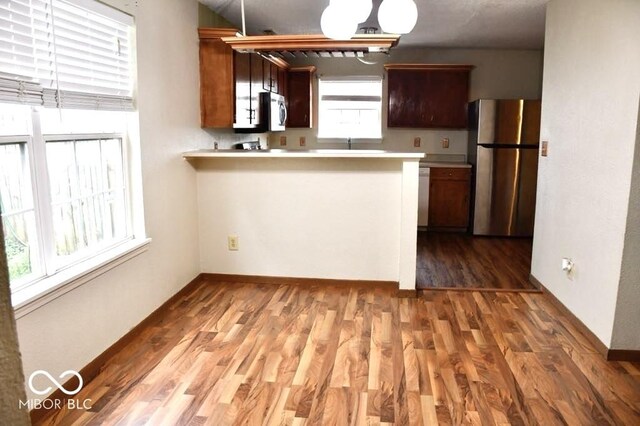 607 Deer Trail Dr, Indianapolis, IN 46217 - kitchen with light countertops, light wood-style floors, a peninsula, and stainless steel appliances