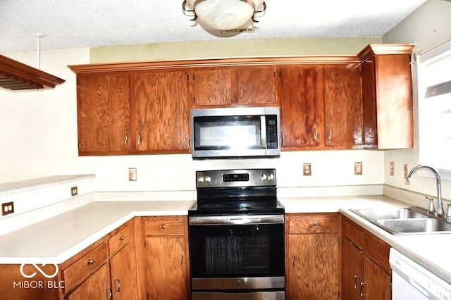 607 Deer Trail Dr, Indianapolis, IN 46217 - kitchen with a textured ceiling, light countertops, a sink, and appliances with stainless steel finishes