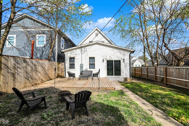 1818 Orleans St, Indianapolis, IN 46203 - rear view of property with a yard, a deck, a fire pit, and a fenced backyard