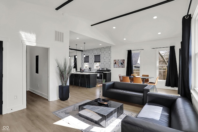 1818 Orleans St, Indianapolis, IN 46203 - living area featuring light wood finished floors, high vaulted ceiling, recessed lighting, baseboards, and visible vents