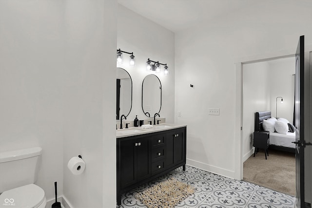 1818 Orleans St, Indianapolis, IN 46203 - ensuite bathroom with toilet, double vanity, baseboards, and a sink