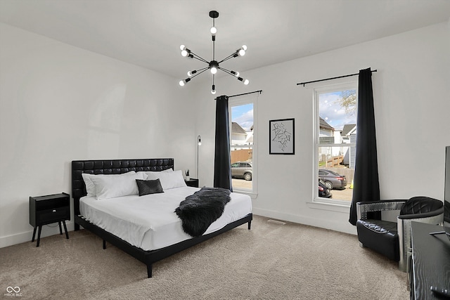 1818 Orleans St, Indianapolis, IN 46203 - carpeted bedroom featuring baseboards, an inviting chandelier, and multiple windows