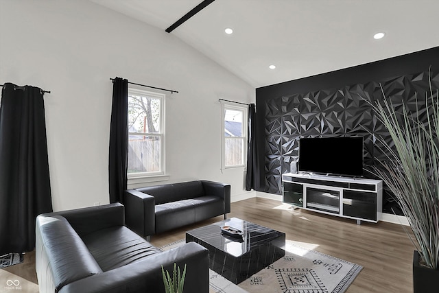 1818 Orleans St, Indianapolis, IN 46203 - living room with recessed lighting, vaulted ceiling, wood finished floors, and an accent wall