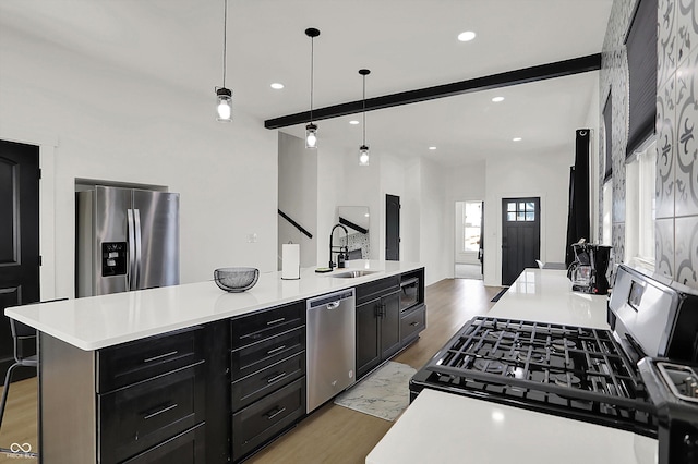 1818 Orleans St, Indianapolis, IN 46203 - kitchen with a sink, light countertops, dark cabinetry, and stainless steel appliances