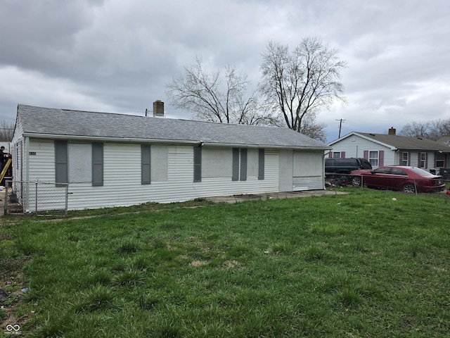 1830 S Chester Ave, Indianapolis, IN 46203 - exterior space with fence, a shingled roof, and a front lawn