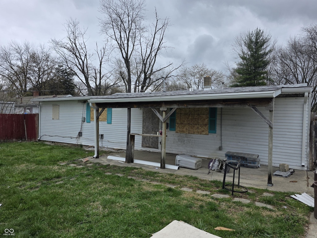 1830 S Chester Ave, Indianapolis, IN 46203 - rear view of house with fence, a yard, and a chimney
