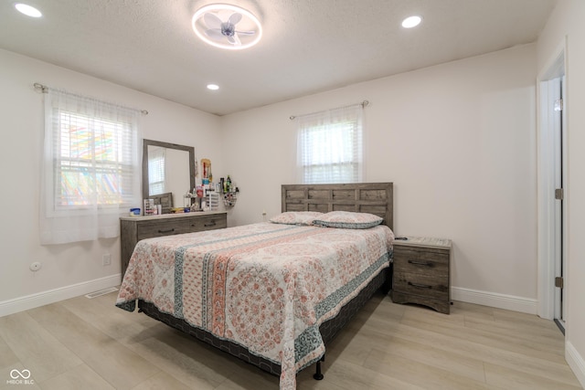 bedroom with recessed lighting, light wood-style flooring, visible vents, and baseboards