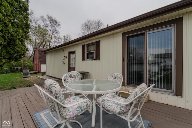 wooden deck with outdoor dining area and fence