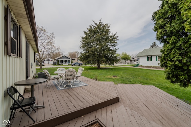 wooden terrace with a lawn