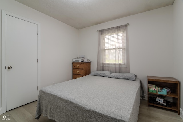 bedroom featuring light wood-style flooring