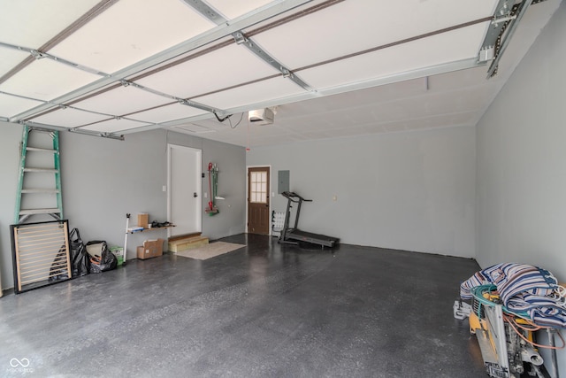 garage with electric panel and a garage door opener