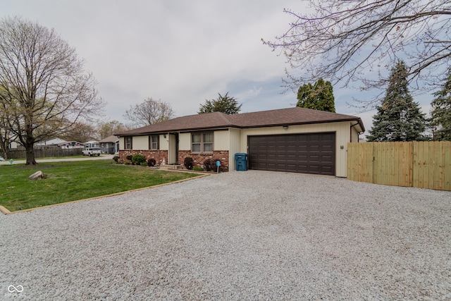 ranch-style house featuring fence, a front lawn, driveway, and a garage