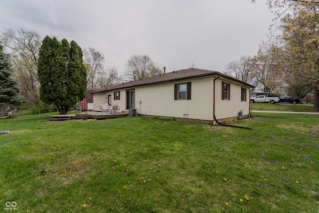 rear view of house with a yard, central AC unit, and a deck