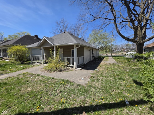 716 Lynn St, Indianapolis, IN 46222 - view of front of property with a porch, a front lawn, and roof with shingles