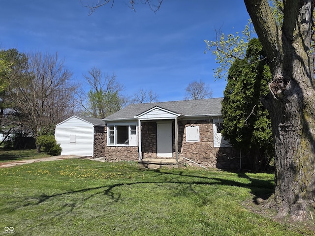 2950 Denison St, Indianapolis, IN 46241 - view of front of house featuring roof with shingles, a front yard, and stone siding