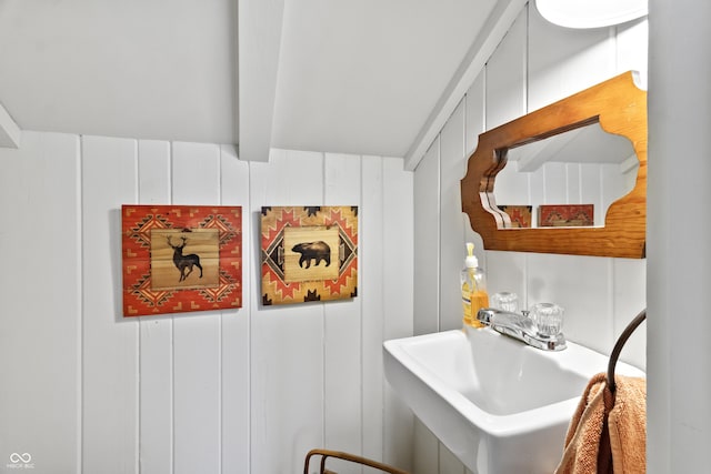 2790 W 50th St, Marion, IN 46953 - bathroom featuring beam ceiling, a sink, and a decorative wall