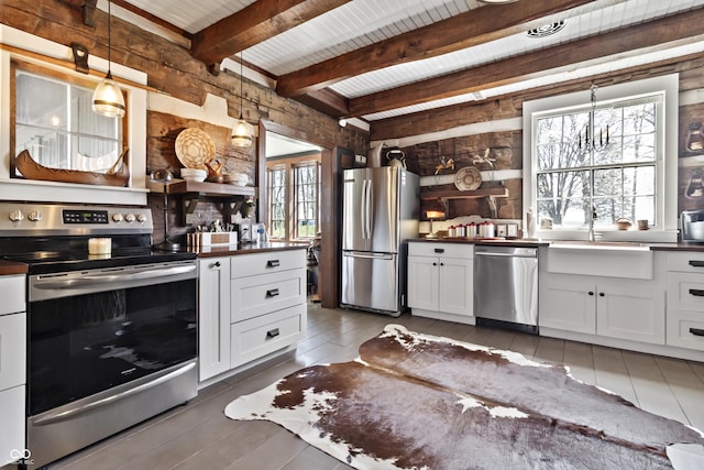 2790 W 50th St, Marion, IN 46953 - kitchen featuring dark countertops, appliances with stainless steel finishes, a sink, white cabinetry, and beamed ceiling